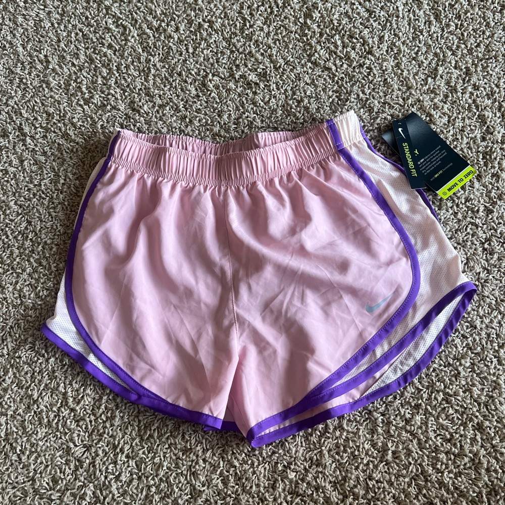 new with tags. pink nike running shorts. size small
